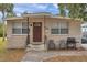 Tan block house with brown door, small front yard, and driveway at 652 13Th S Ave, St Petersburg, FL 33701