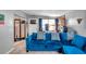 Cozy living room featuring a large blue sectional sofa at 652 13Th S Ave, St Petersburg, FL 33701
