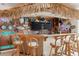 L-shaped tropical bar with multiple TVs, games, and island decor at 657 Garland Cir, Indian Rocks Beach, FL 33785