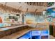 Tropical-themed bar with a mural, lighting, and storage at 657 Garland Cir, Indian Rocks Beach, FL 33785