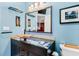 Bathroom boasts a modern vanity with vessel sink and large mirror at 657 Garland Cir, Indian Rocks Beach, FL 33785
