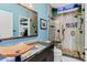 Spa-like bathroom with walk-in shower, unique sink, and pebble tile at 657 Garland Cir, Indian Rocks Beach, FL 33785