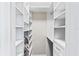 Spacious walk-in closet with ample shelving and hanging rod at 657 Garland Cir, Indian Rocks Beach, FL 33785