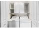 Laundry room with washer, dryer, and overhead cabinets at 657 Garland Cir, Indian Rocks Beach, FL 33785