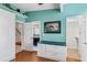 Home office with built-in desk and adjacent bathroom access at 657 Garland Cir, Indian Rocks Beach, FL 33785