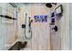 Elegant shower with glass enclosure, stone accents, and built-in shelving at 657 Garland Cir, Indian Rocks Beach, FL 33785