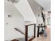 Indoor staircase with wood railing and cable accents at 657 Garland Cir, Indian Rocks Beach, FL 33785