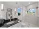 Clean bathroom, featuring a large shower and dark vanity at 720 16Th Ne Ave, St Petersburg, FL 33704