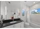 Clean and modern bathroom with a bathtub, shower, and dark vanity at 720 16Th Ne Ave, St Petersburg, FL 33704