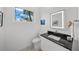 Modern bathroom with dark vanity, toilet and walk-in shower at 720 16Th Ne Ave, St Petersburg, FL 33704