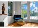 Relaxing sitting area with blue velvet chair and leopard ottoman at 720 16Th Ne Ave, St Petersburg, FL 33704