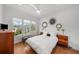 Spacious bedroom with hardwood floors, large windows, and mid-century modern furniture at 720 16Th Ne Ave, St Petersburg, FL 33704