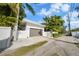 Modern garage with a large brown door and white exterior at 720 16Th Ne Ave, St Petersburg, FL 33704