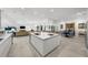 Open concept kitchen with island, stainless steel appliances, and views to dining & living areas at 720 16Th Ne Ave, St Petersburg, FL 33704