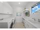 Bright laundry room with a sink and built-in cabinets at 720 16Th Ne Ave, St Petersburg, FL 33704