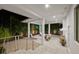 Covered patio with lounge chairs and a grill at night at 720 16Th Ne Ave, St Petersburg, FL 33704