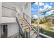 Modern light-filled staircase with metal railing and wood steps at 720 16Th Ne Ave, St Petersburg, FL 33704