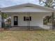 Ranch house with carport and black framed windows at 8002 Sane Pl, Tampa, FL 33610