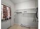 Laundry room with shelving and exterior access at 8002 Sane Pl, Tampa, FL 33610