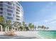 Relaxing beachfront setting with lounge chairs and tropical landscaping at 805 S Gulfview Blvd # 607A, Clearwater, FL 33767