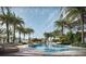 Resort-style pool with plenty of lounge chairs and tropical landscaping at 805 S Gulfview Blvd # 607A, Clearwater, FL 33767