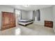 Bedroom with gray walls, tiled floors, two dressers, and two windows at 8204 N 13Th St, Tampa, FL 33604