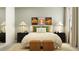 Bright bedroom with cozy bedding, stylish nightstands, and decorative wall art at 8517 Bella Mar Trl, Parrish, FL 34219