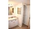 Bathroom with single vanity, linen closet, and a large mirror at 946 Virginia St # 102, Dunedin, FL 34698