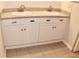 Double vanity bathroom with granite countertop and white cabinets at 946 Virginia St # 102, Dunedin, FL 34698