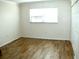 Bedroom with wood-look tile flooring and double closets at 946 Virginia St # 102, Dunedin, FL 34698