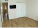 Bedroom with wood-look tile floors and access to hallway at 946 Virginia St # 102, Dunedin, FL 34698
