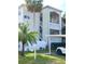 Exterior view of a two-story building with palm trees at 946 Virginia St # 102, Dunedin, FL 34698