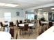 Large community room with multiple tables and chairs at 946 Virginia St # 102, Dunedin, FL 34698