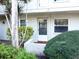 Exterior view of condo building showcasing landscaping and entrance at 946 Virginia St # 102, Dunedin, FL 34698