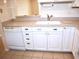 White cabinets and granite countertops in kitchen at 946 Virginia St # 102, Dunedin, FL 34698