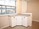 Kitchen with additional counter space and white cabinets at 946 Virginia St # 102, Dunedin, FL 34698