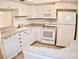 Well-equipped kitchen with white cabinets and granite countertops at 946 Virginia St # 102, Dunedin, FL 34698