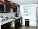 Well-equipped kitchen with granite countertops and dark wood cabinets at 946 Virginia St # 102, Dunedin, FL 34698