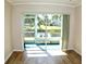 Living area with sliding doors leading to a tranquil water view at 946 Virginia St # 102, Dunedin, FL 34698