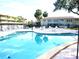 Community pool with surrounding patio furniture at 946 Virginia St # 102, Dunedin, FL 34698