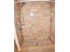 Large walk-in shower with neutral tile and grab bars at 946 Virginia St # 102, Dunedin, FL 34698