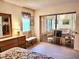 Bedroom with sliding glass doors leading to a sunroom at 1040 Bowsprit Ln # 1306, Holiday, FL 34691