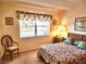 Bedroom with window, chair and floral bedding at 1040 Bowsprit Ln # 1306, Holiday, FL 34691