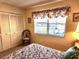 Bedroom with window, chair and floral bedding at 1040 Bowsprit Ln # 1306, Holiday, FL 34691