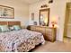 Bedroom with floral bedding, dresser and window at 1040 Bowsprit Ln # 1306, Holiday, FL 34691