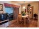 Dining area with table, chairs, and access to a sunroom at 1040 Bowsprit Ln # 1306, Holiday, FL 34691