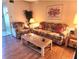 Living room with wood floors, sofa, and armchairs at 1040 Bowsprit Ln # 1306, Holiday, FL 34691