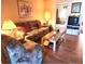 Living room featuring a sofa, armchairs, and coffee table at 1040 Bowsprit Ln # 1306, Holiday, FL 34691