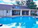 Community pool with patio furniture at 1040 Bowsprit Ln # 1306, Holiday, FL 34691