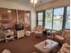 Relaxing sunroom with wicker furniture and lake view at 1040 Bowsprit Ln # 1306, Holiday, FL 34691
